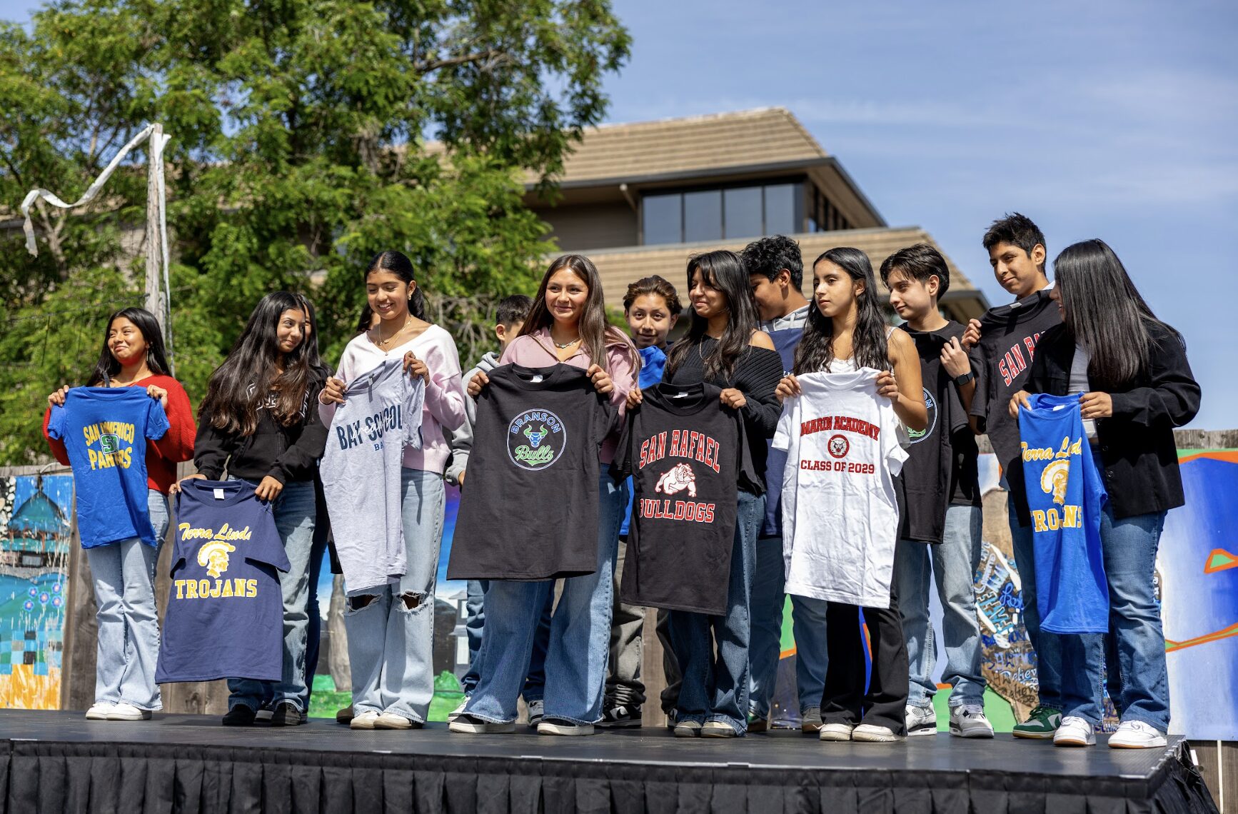 group,teens,holding t-shirts
